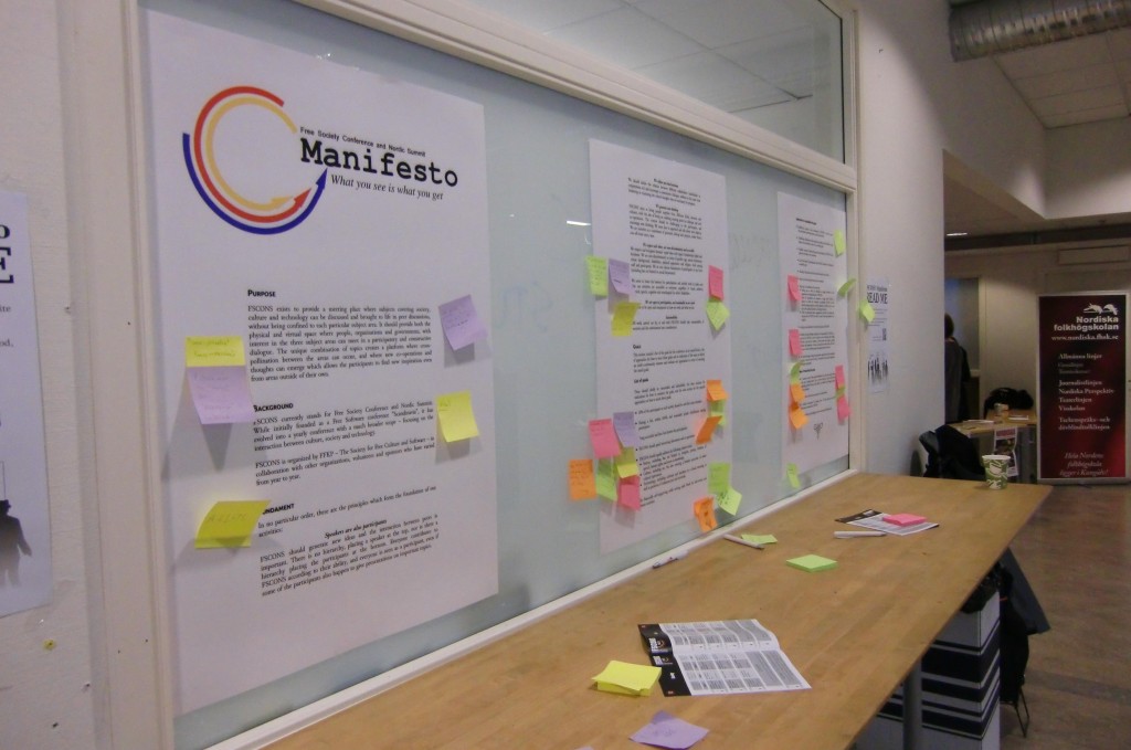 Print out of Manifesto plastered with sticky notes on whiteboard