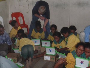 children fiddling with the OLPC for the first time
