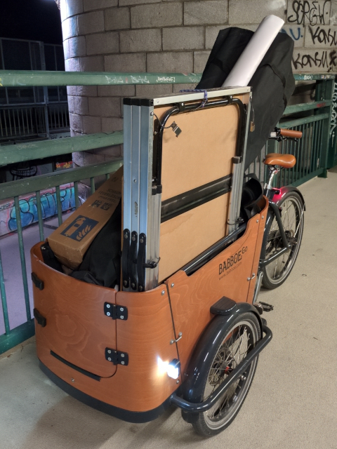A cargo bike loaded with all information desk materials including a tent